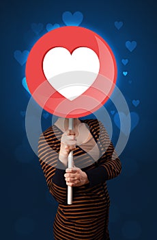 Woman holding heart sign