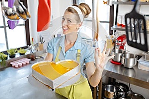 Woman holding heartshape cake