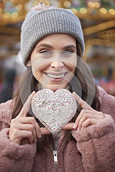 Woman holding a heartshape gingerbread cookie photo