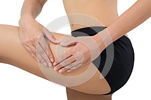 Woman holding her beautiful healthy body with massaging thigh in pain area.