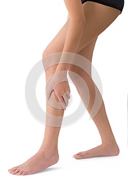 Woman holding her beautiful healthy long leg with massaging shin and calf in pain area.