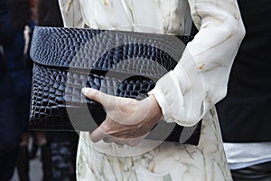 A woman holding her clutch purse outdoors photo