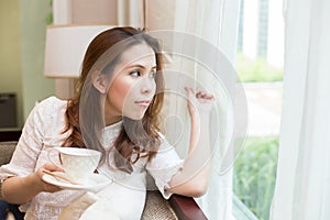 Woman holding her coffee cup