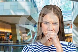 Woman holding her nose