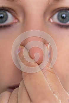 Woman holding her nose, concept anosmia or hyposma, rhinaesthesia