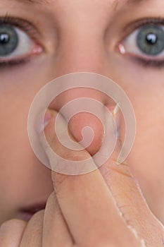 Woman holding her nose, concept anosmia or hyposma, rhinaesthesia photo
