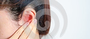 Woman holding her painful Ear. Ear disease, Atresia, Otitis Media, Inflation, Pertorated Eardrum, Meniere syndrome, photo