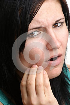 woman holding her painful jawbone photo