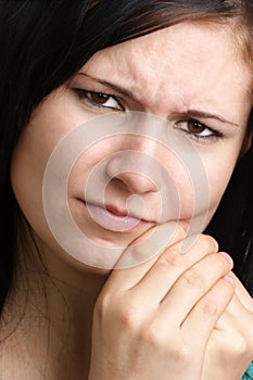 woman holding her painful jawbone photo