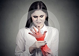 Woman holding her painful wrist