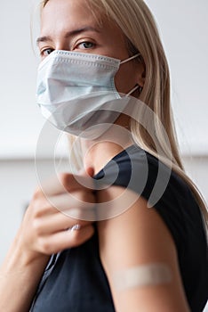 Woman holding her shirt sleeve after receiving vaccination