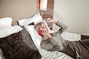 Woman holding her smartphone having phone conversation