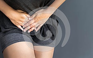 Woman holding her stomach and in pain rushing to the bathroom. Bladder and menstrual problems