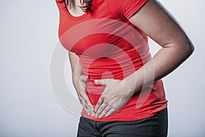 Woman holding her tummy and suffering from menstrual cramps