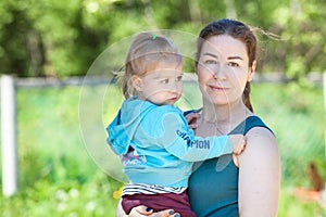 Woman holding her two-year-old daughter in her arms