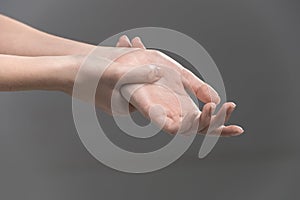 Woman holding her wrist - pain concept.