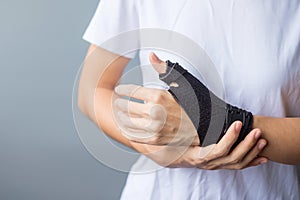 Woman holding her wrist pain because using smartphone or computer long time. De Quervain`s tenosynovitis, Intersection Symptom,