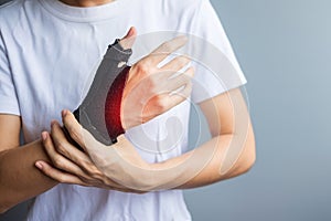 Woman holding her wrist pain because using smartphone or computer long time. De Quervain`s tenosynovitis, Intersection Symptom,