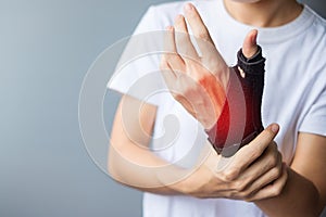 Woman holding her wrist pain because using smartphone or computer long time. De Quervain`s tenosynovitis, Intersection Symptom,