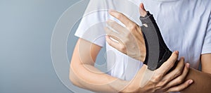 Woman holding her wrist pain because using smartphone or computer long time. De Quervain`s tenosynovitis, Intersection Symptom,