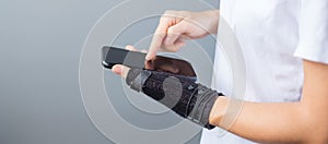 Woman holding her wrist pain because using smartphone long time. De Quervain`s tenosynovitis, Intersection Symptom, Carpal Tunnel