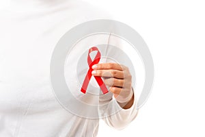 Woman holding HIV AIDS awareness red ribbon
