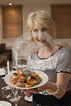 Woman Holding Hors D'oeuvres On Plate photo