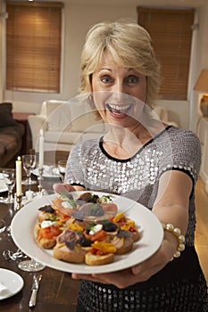 Woman Holding Hors D'oeuvres On Plate photo