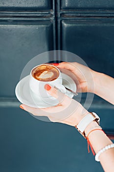 Woman holding hot cup of coffee