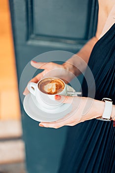 Woman holding hot cup of coffee