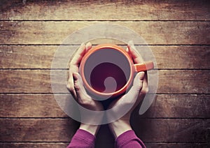 Woman holding hot cup of tea