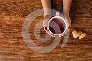 Woman holding hot cup of tea