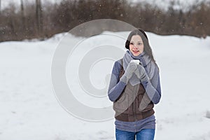Woman holding hot drink outside