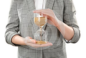 Woman holding hourglass on white background. Time management concept