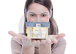 Woman holding a house in her hands.