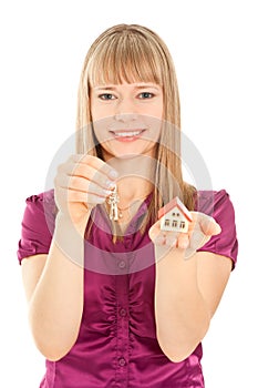 Woman holding house and keys (focus on woman)