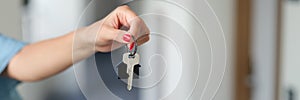Woman holding house keys, hands close-up
