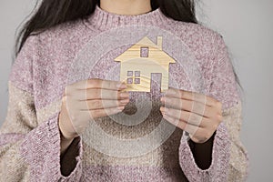 Woman holding house model