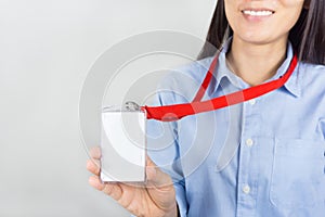 Woman holding Identification card.