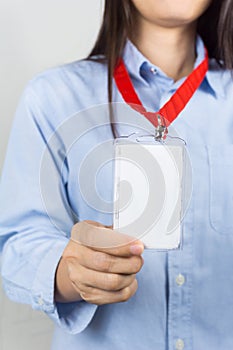 Woman holding Identification card.