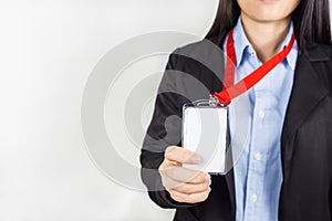 Woman holding Identification card.
