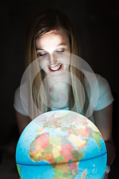 Woman holding an illuminated globe