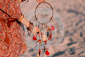 Woman holding Indian decoration against backdrop bich