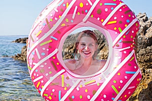 Woman holding inflatable doughnut