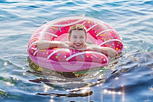 Woman holding inflatable doughnut