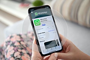 Woman holding iPhone 11 with social networking service WhatsApp