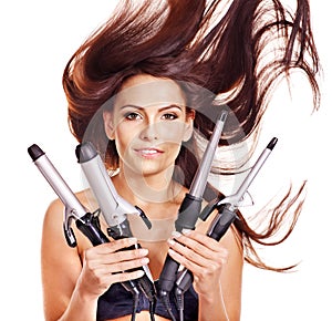 Woman holding iron curling hair.