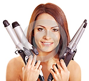 Woman holding iron curling hair.