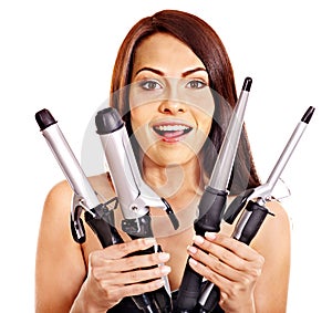 Woman holding iron curling hair.