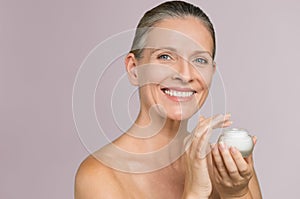 Woman holding jar of moisturizer